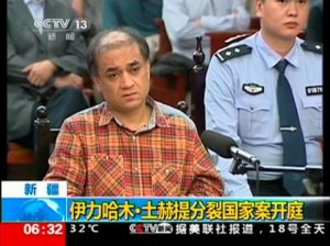 Uighur academic Ilham Tohti sits during his trial on separatism charges in Urumqi, Xinjiang region