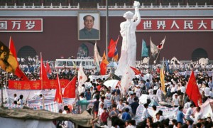 BEIJING, CHINA - 1989/06/01: The "Goddess of Democracy" stands tall amid a huge crowd of flag waving pro-democracy demonstrators in front of the Mao Tse Tung portrait in Tiananmen Square. Art students made the polystyrene and plaster statue in the style of the Statue of Liberty to represent their desire for a more democratic rule in Communist China. Once erected in Tiananmen Square this proved to be the last act of defiance by protestors as a few days later government troops brutally suppressed the democratic movement.. (Photo by Peter Charlesworth/LightRocket via Getty Images)