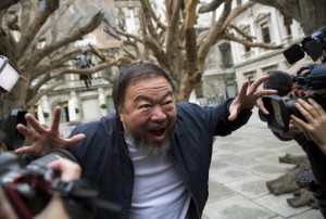 Chinese artist Ai Weiwei poses for photographers during a photocall for his exhibition at the Royal Academy of Arts in London, Britain September 15, 2015. REUTERS/Neil Hall