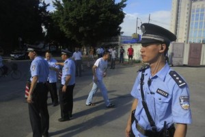 Police officers stand guard outside the court house, blocking roads to the Guangzhou People's Court in the southern Chinese city of Guangzhou September 12, 2014. REUTERS/James Pomfret/Files