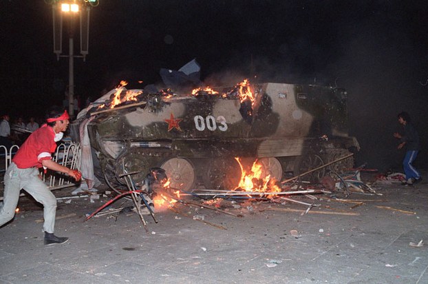 An armored personnel carrier is shown in flames