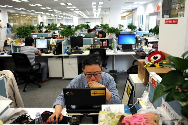 Man using a laptop at a Beijing office of Sina Weibo