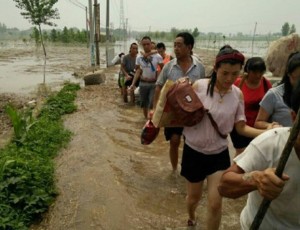 Villagers in China's flooded northern province of Hebei flee rising waters