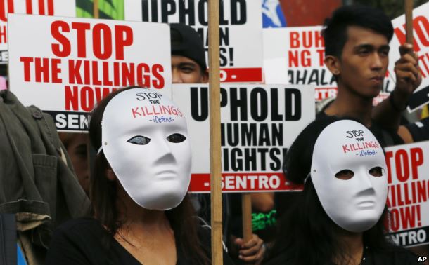 masked-protesters-gather-for-a-rally-near-the-presidential-palace-to-mark-international-human-rights-day-in-manila