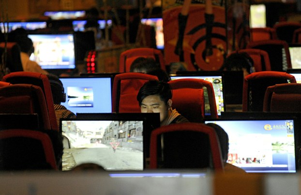 man surfs the Internet at a coffee shop in Beijing in a file photo