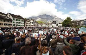 People hold up their voting cards during the annual Landsgemeinde meeting in Glarus