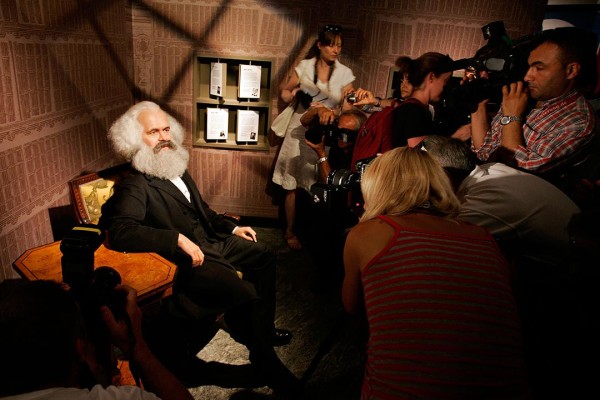 BERLIN - JULY 03: Journalists take pictures of a wax model of Karl Marx in the Berlin Branch of Madame Tussauds on July 3, in Berlin, Germany. The famous Madame Tussauds wax figure cabinett is due to open its location in Berlin on July 9th. (Photo by Steffen Kugler/Getty Images)