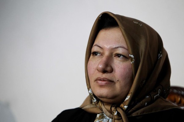 Sakineh Mohammadi Ashtiani, an Iranian woman sentenced to death by stoning for adultery, speaks during an interview with a group of journalists from international news networks at a guesthouse belonging to a government welfare organisation in Iran's northwestern city of Tabriz on January 1, 2011. The 43-year-old woman said that she would sue two German journalists who have been jailed in Iran for interviewing her son. AFP PHOTO/ATTA KENARE / AFP / ATTA KENARE