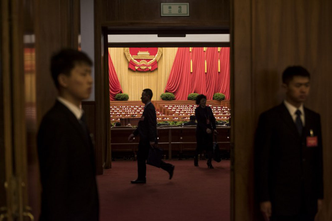 Security guards check an the entrance during the third plenary session of the National People's Congress at the Great Hall of the People in Beijing on March 13, 2016. China's leaders are meeting this week for the annual rubber-stamp National People's Congress, where Premier Li Keqiang set a growth target of 6.5-7.0 percent for this year. / AFP PHOTO / FRED DUFOUR