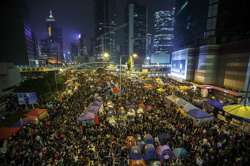 Pro-democracy protesters gather at the Occupy Central protest site in Admiralty in Hong Kong December 10, 2014. Hong Kong urged pro-democracy protesters to pack up their tents and leave their main camp near government headquarters, saying it could not promise there would be no "confrontations" when the site is cleared on Thursday. REUTERS/Athit Perawongmetha (CHINA - Tags: POLITICS CIVIL UNREST TPX IMAGES OF THE DAY)