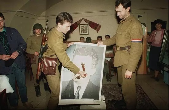 1989年12月28日，倒向人民的罗马尼亚士兵用刺刀戳破齐奥塞斯库的画像。